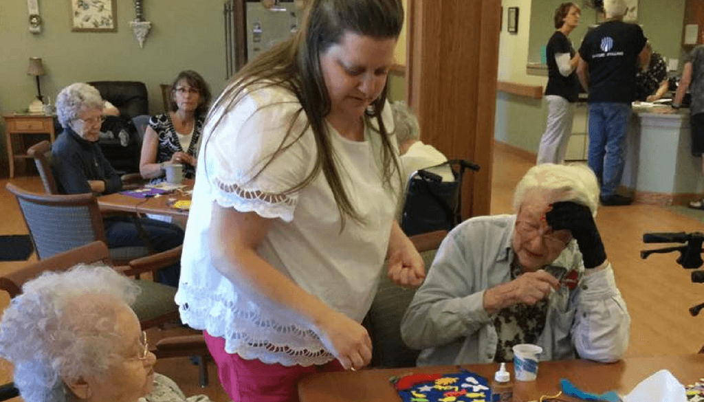 Volunteers assisting residents with crafting activity at The Neighbors of Dunn County.