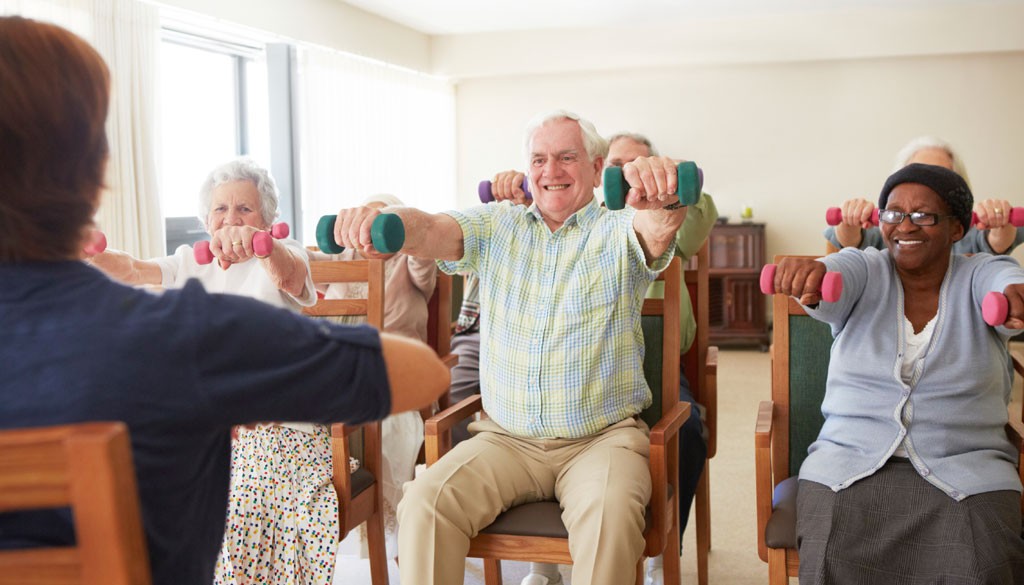 Senior citizens using light dumbells for a low impact workout.