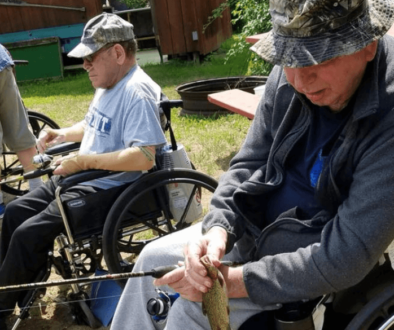 Resident from The Neighbors of Dunn County sitting in wheelchairs fishing.