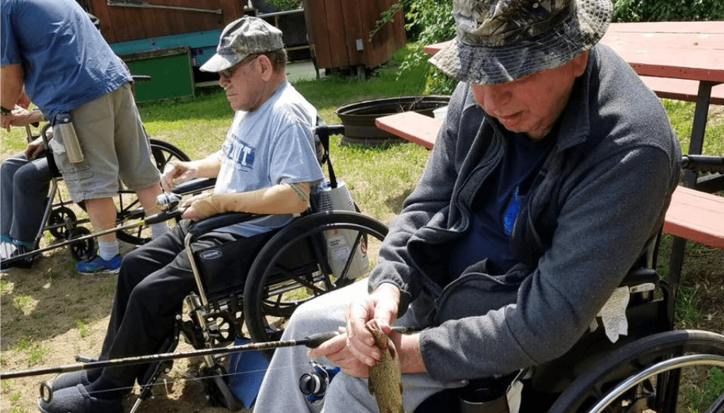 Resident from The Neighbors of Dunn County sitting in wheelchairs fishing.