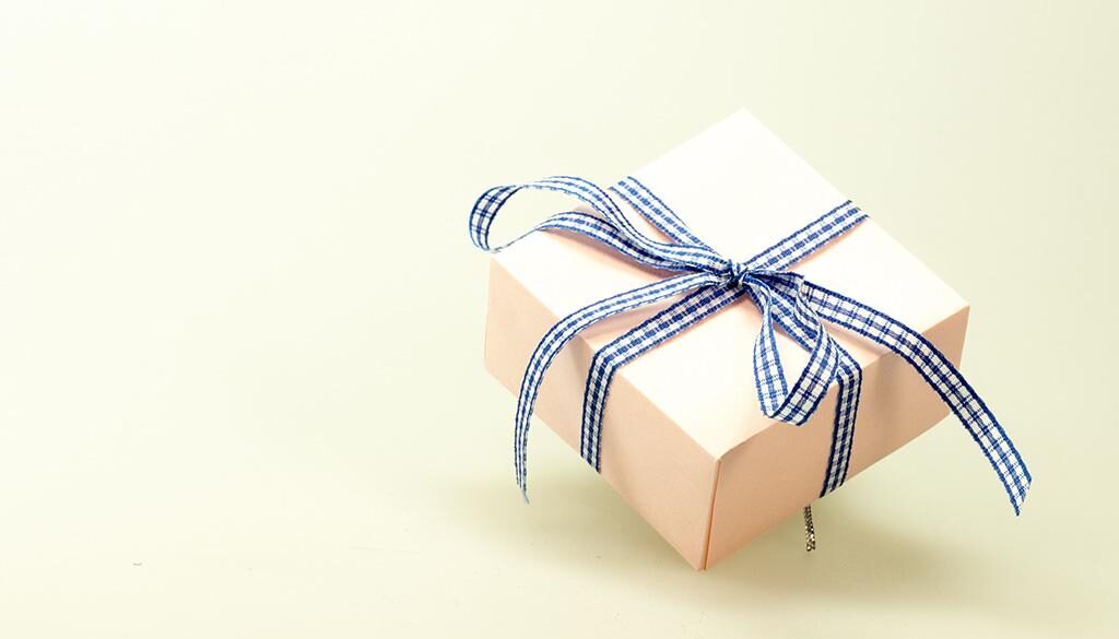 A wrapped gift box with a bowtie.