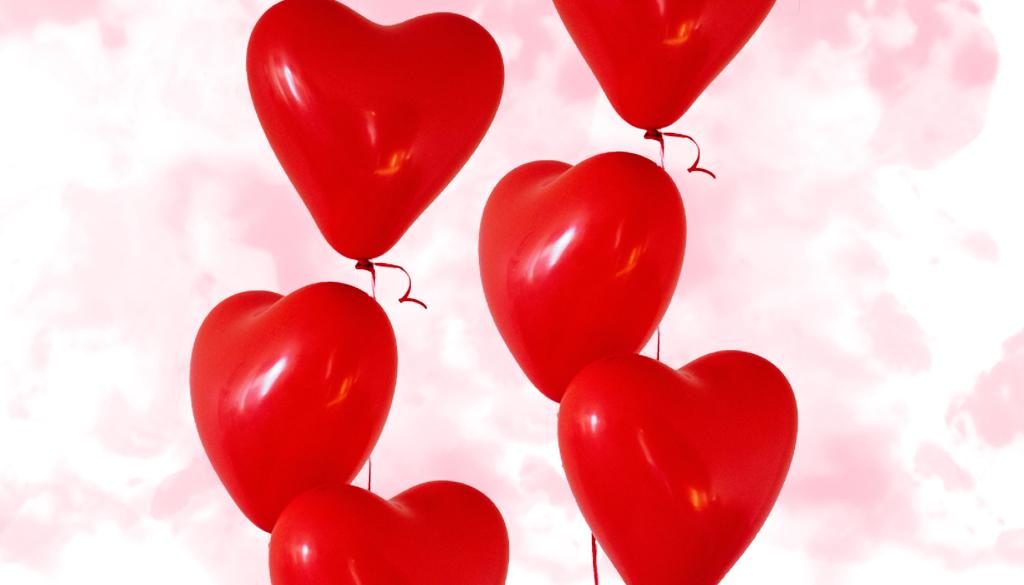 Heart balloons on a pink smokey background.