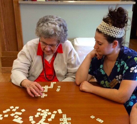 Resident and staff playing word games.