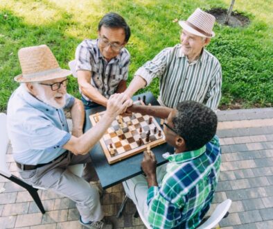 A group of active seniors bonding over the summer fun activity of chess.