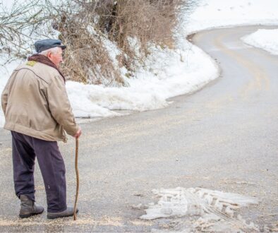Elderly man walking in winter.