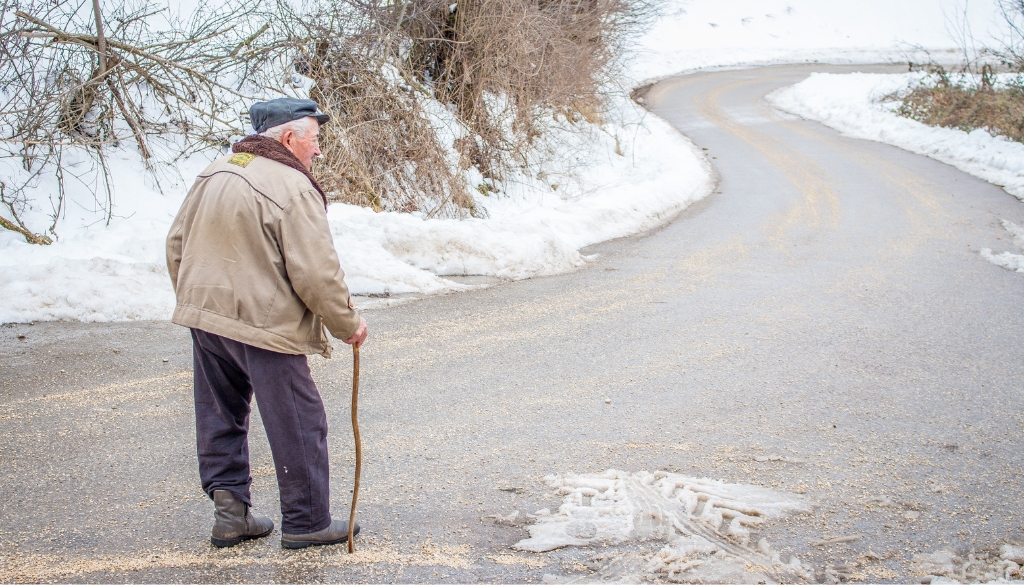 Elderly man walking in winter.