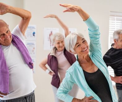 Elderly people stretching in an exercise class.