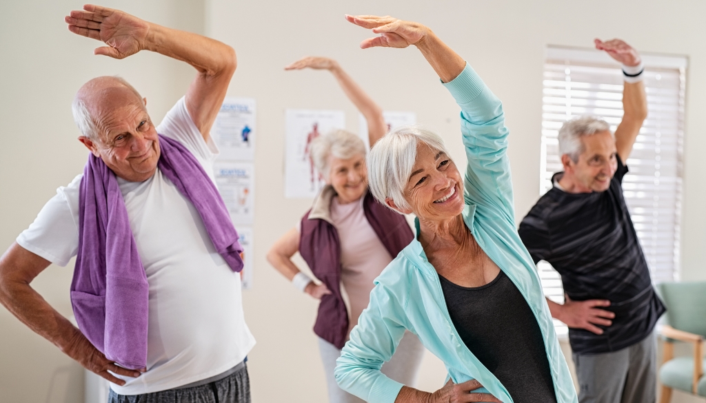 Elderly people stretching in an exercise class.