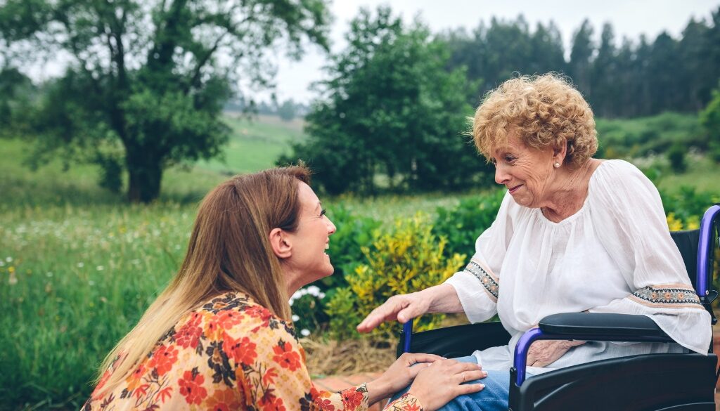 Woman visiting her grandmother in a nursing home during Spring.