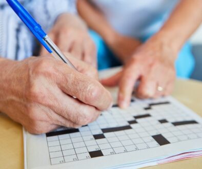 A couple completing a crossword puzzle.