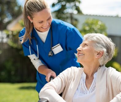 CNA smiling with an elderly patient.