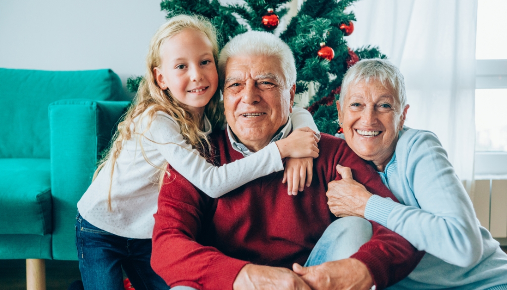 Preparing For The Holidays With A Loved One In A Nursing Home A granddaughter visiting her grandparents during Christmas.
