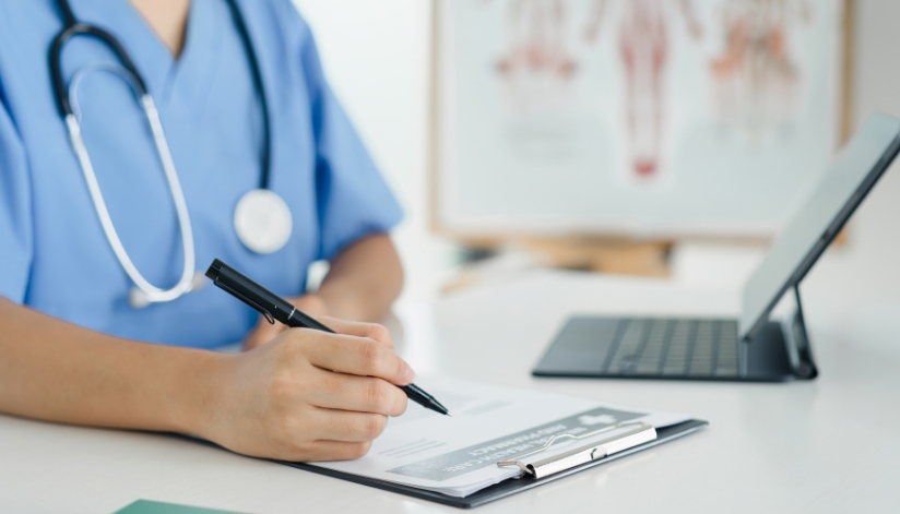 Celebrating Health Information Professionals Week Healthcare professional filling out a patient form.