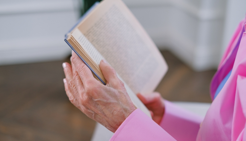 the-neighbors-of-dunn-county-elderly-woman-reading-book Elderly woman reading a book.