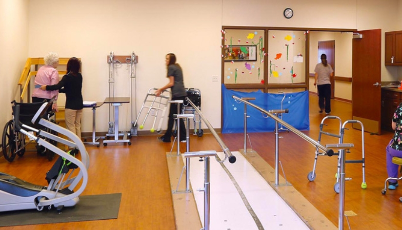 Nursing staff at The Neighbors of Dunn County in Menomonie, WI working with a patient on mobility and physical therapy.